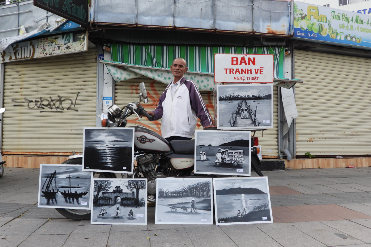 Local artist drawing a portrait for a tourist at Nha Trang Night Market